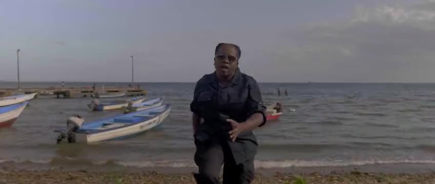 A worship film recorded on a beach beside fishing boats